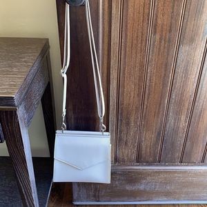 Cream two pocket purse with detachable straps.